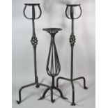 A Pair of Wrought Iron Tripod Candle Stands and a Smaller Example, 79.5cm high
