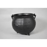 A Large Cast Iron Cauldron on Three Feet, Loop Carrying Handle, 48cm Diameter and 37cm high