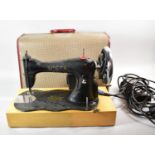 A Vintage Electric Singer Sewing Machine with Foot Pedal