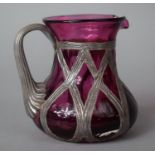 A White Metal Overlaid Cranberry Glass Jug, 9cm High