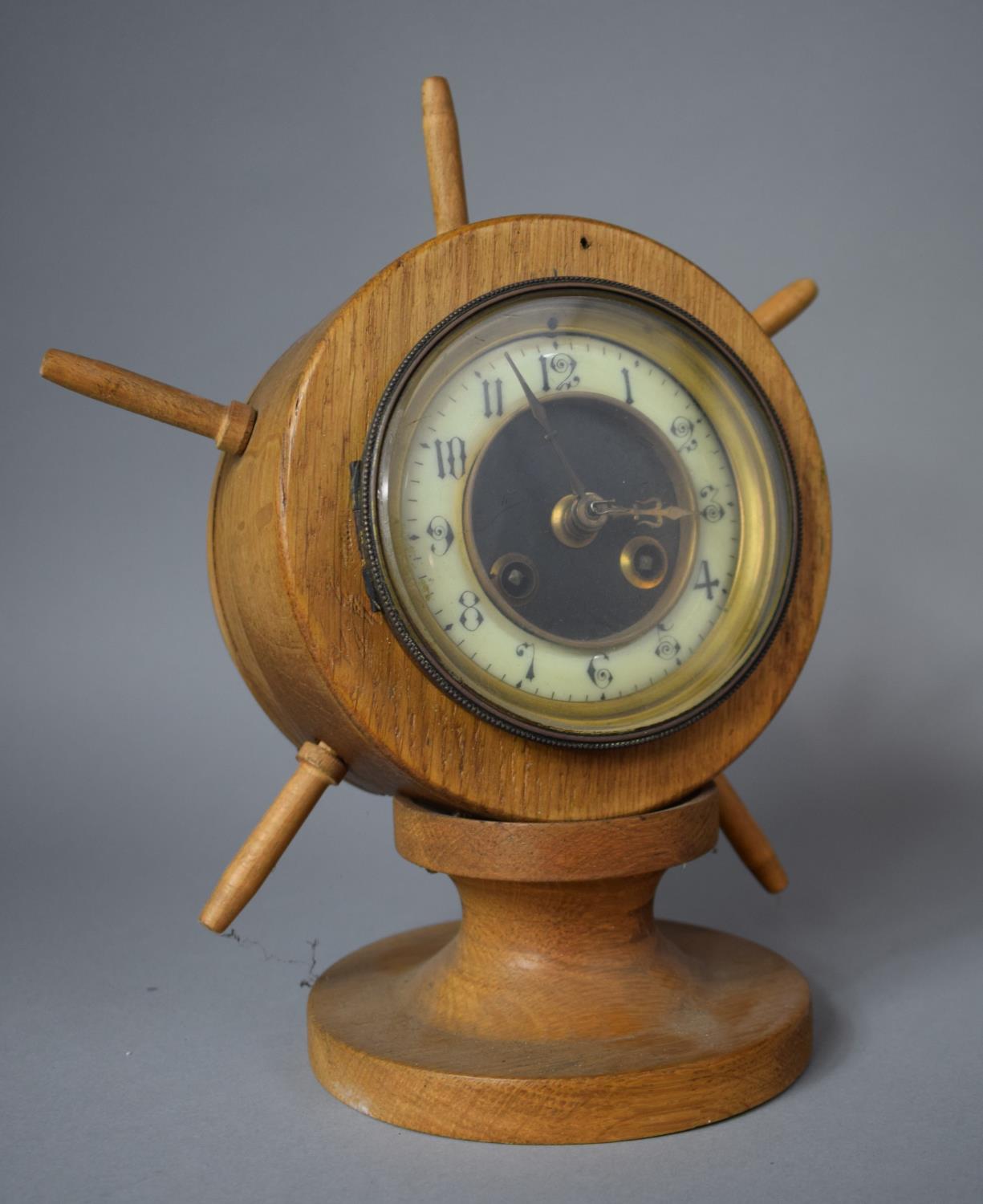 A Novelty Mantle Clock in the Form of a Ships Wheel on Turned Wooden Socle, 28cm high