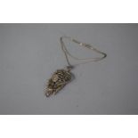 A Silver and Marcasite Pendant in the Art Nouveau Style with Maiden with Flowers on Italian Chain