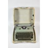 A Vintage Olympia Manual Portable Typewriter in Metal Case