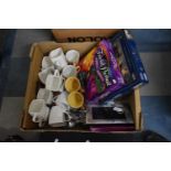 A Box Containing Kitchen Mugs, Stainless Steel Cutlery, Photoframes, Jigsaw Puzzle etc