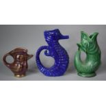 A Dartmouth Devon Green Glazed Gluggle Jug, Lustre Bird Jug and Blue Glazed Seahorse Jug, 25cm high