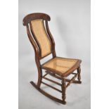 A Late Victorian Cane Seated and Backed Rocking Chair