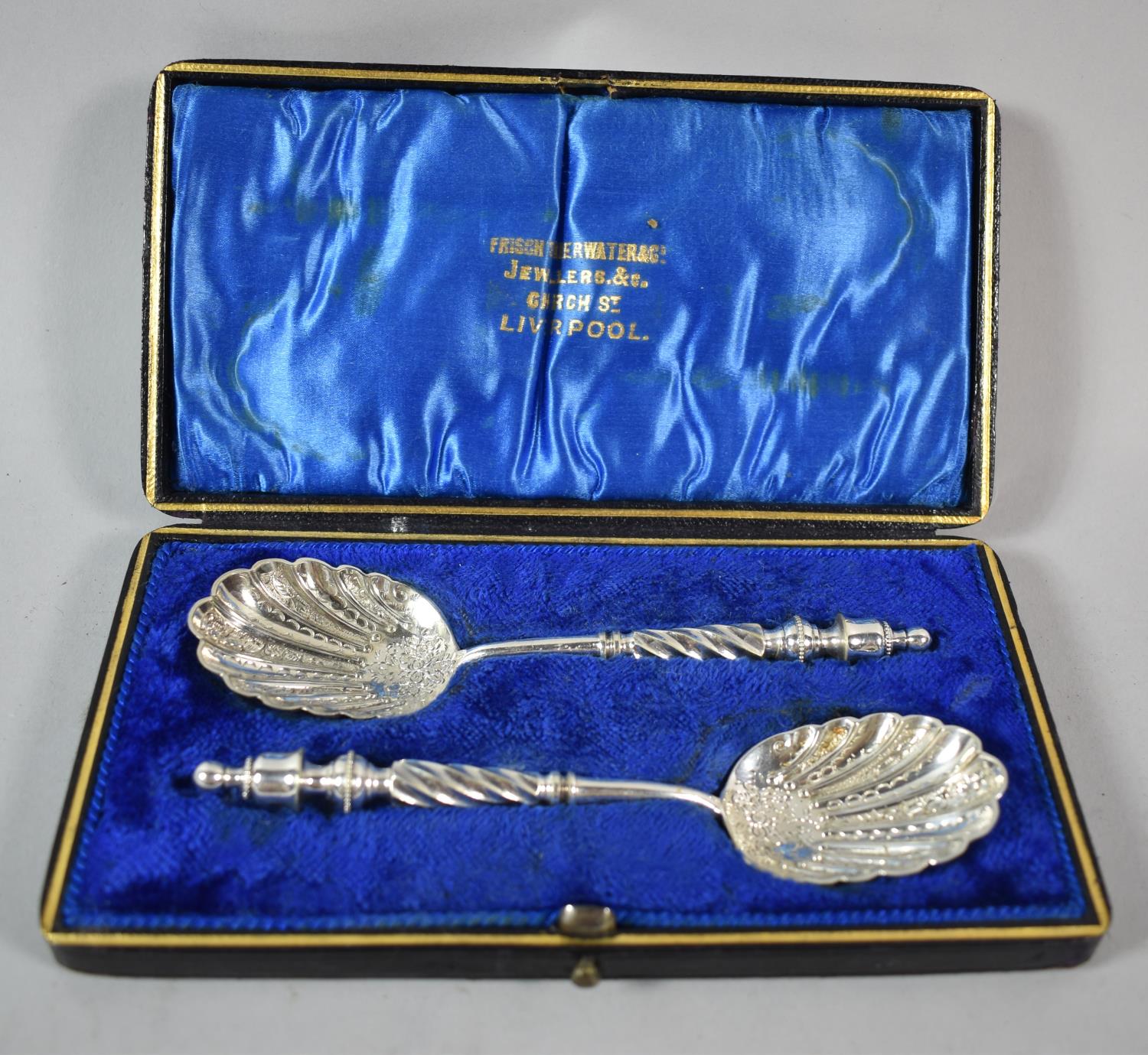 A Cased Pair of Silver Plated Spoons with Engraved Shell Bowls and Barley Twist Handles