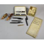 A Collection of Curios to Include Various Pens, Two Carved Black Forest Wine Saver Corks, Box of