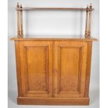 An Edwardian Oak Side Cupboard with Raised Shelf on Four Turned Supports, Panelled Doors to