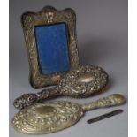 A Collection of Silver Mounted Items to Include Easel Back Photo Frame, Needlecase and Hair Brush