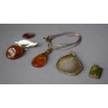 A Collection of Amber and Hardstone Pendants etc