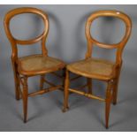 A Pair of Balloon Back Cane Seated Satinwood Framed Bedroom Chairs