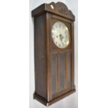 An Edwardian Oak Wall Clock, 74cm high