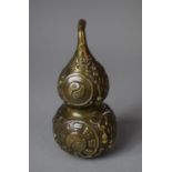 A Chinese Bronze Double Gourd with Relief Decoration, 13cm high