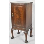 An Edwardian Mahogany Bedside Cupboard with Panelled Door to Shelved Interior, Short Cabriole