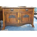 An Art Nouveau Mahogany Sideboard with Two Drawers Over Cupboard Having Carved Panelled Doors, 145cm