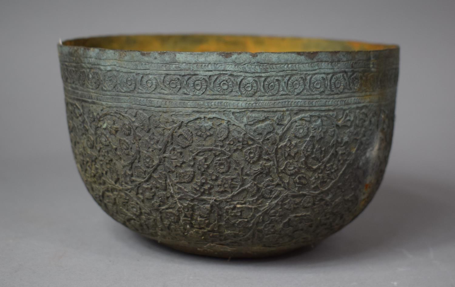 A Far Eastern Intricately Etched White Metal Bowl with Verdigris Finish, Decorated in Relief with