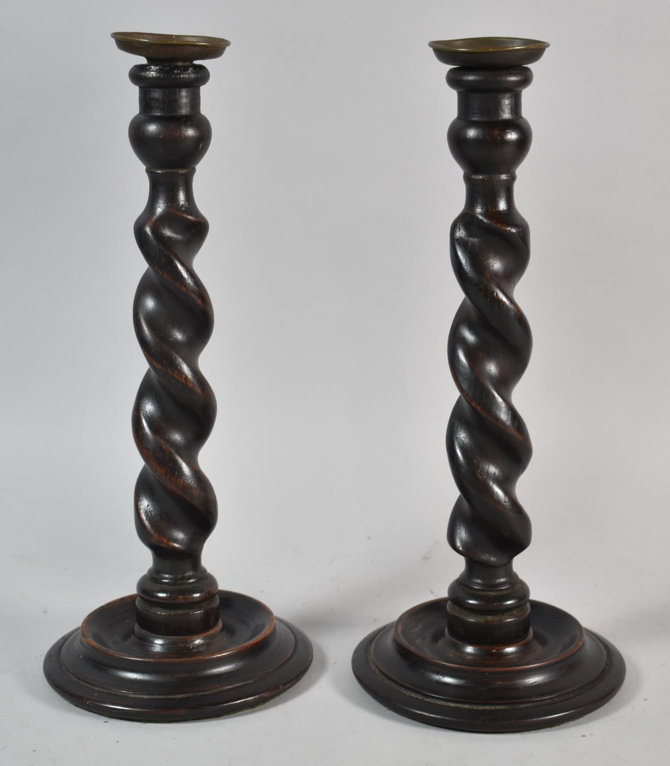 A Pair of Edwardian Oak Barley Twist Candlesticks on Circular Bases, 32cm high