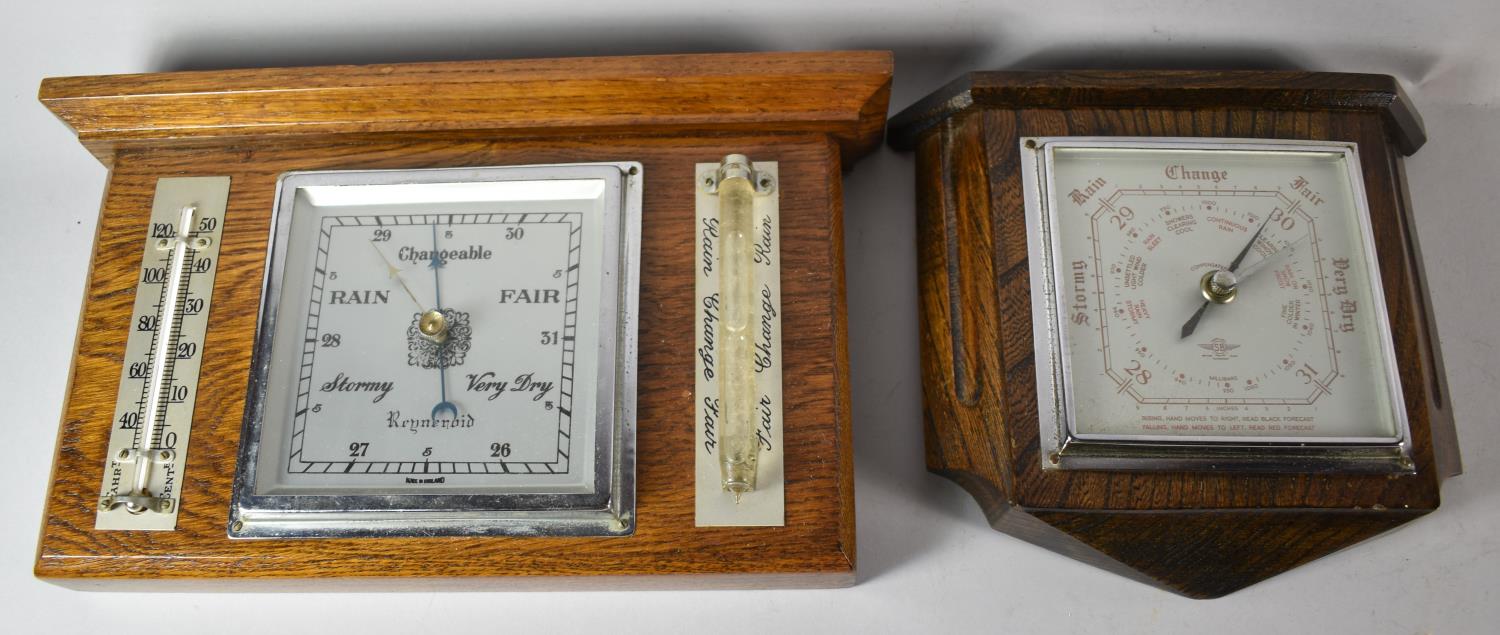 An Edwardian Oak Wall Hanging Weather Station, 32cm wide and a Similar Aneroid Barometer, 22cm wide