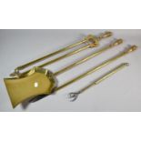 A Set of Three Long Handled Brass Fire Irons and a Retractable Brass Toasting Fork