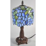 A Reproduction Bronze Effect Table Lamp with Tiffany Style Shade, 33cm high