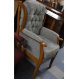 A Modern Framed Wing Armchair with Buttoned Back Cushion