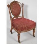 A Victorian Walnut Framed Ladies Nursing Chair, with Upholstered Oval Back, Turned Reeded Supports
