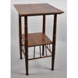 An Early 20th Century Walnut Arts and Crafts Two Tier Occasional Table on Turned Supports with