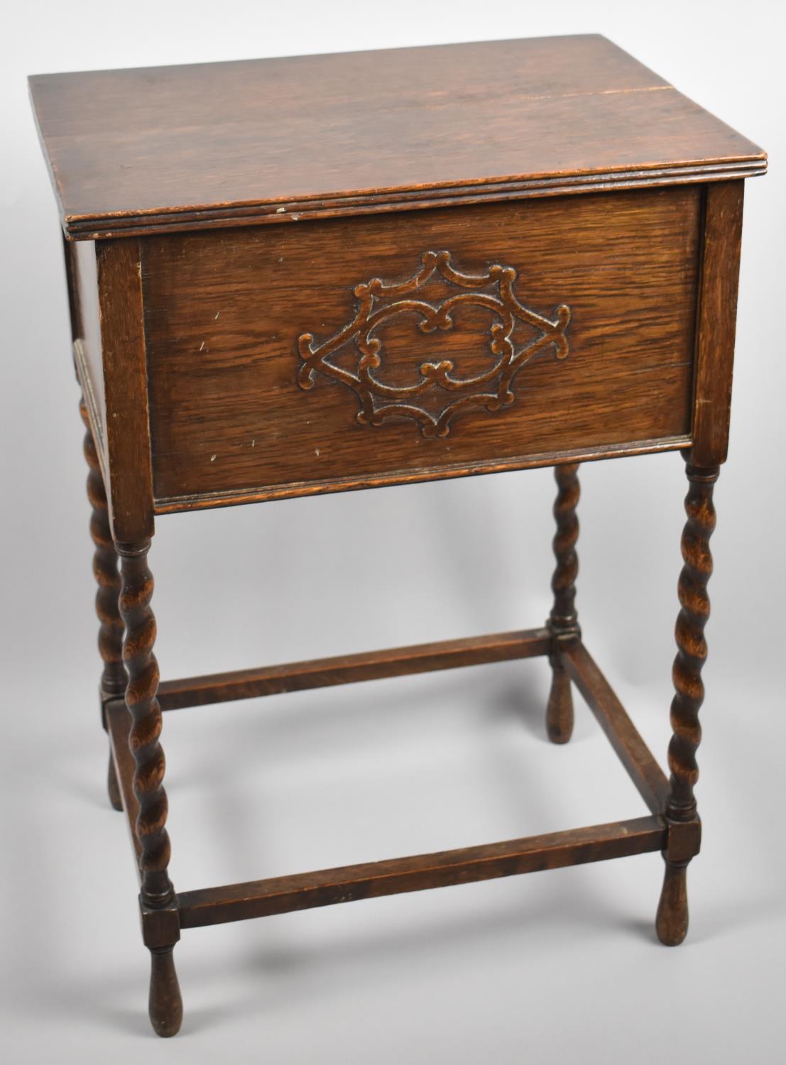 A Mid 20th Century Oak Lift Top Sewing Box on Barley Twist Supports, 62cm high
