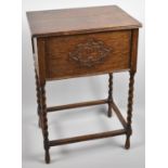 A Mid 20th Century Oak Lift Top Sewing Box on Barley Twist Supports, 62cm high