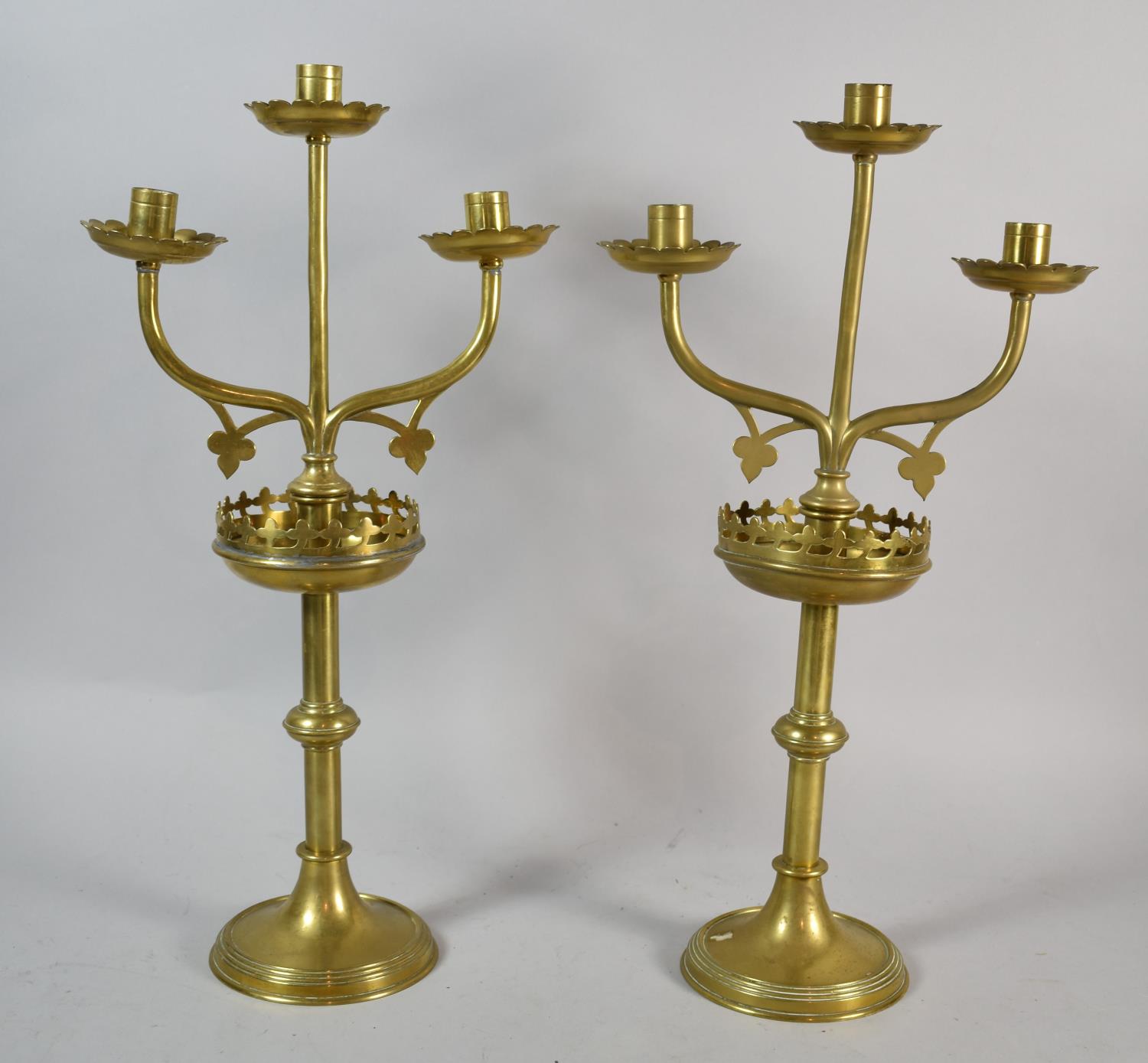 A Pair of Ecclesiastical Brass Three Branch Candelabra on Circular Bases, 46cm high