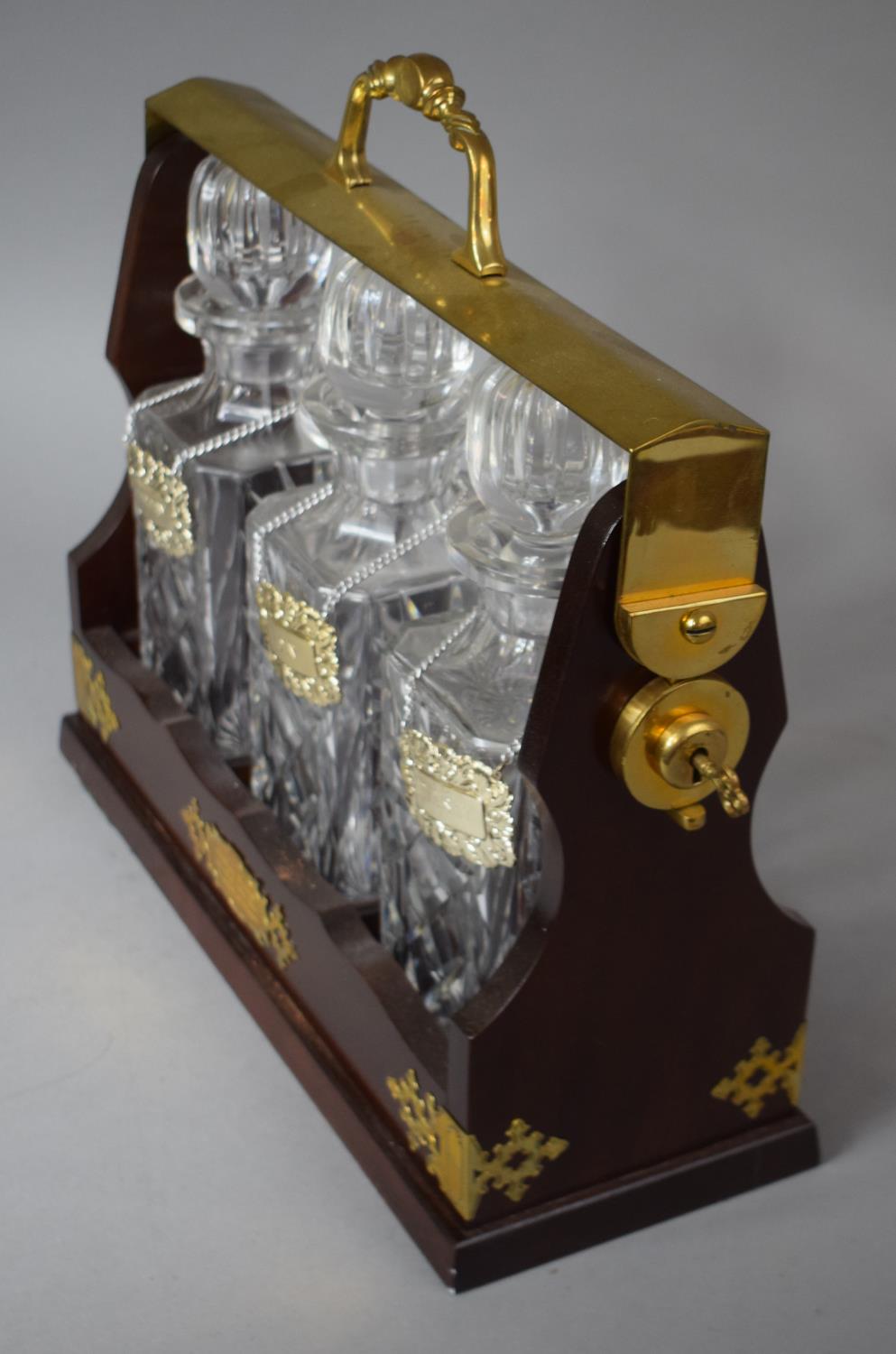 A Modern Brass Mounted Three Bottle Tantalus with Decanter Labels for Sherry, Gin and Whisky, - Image 2 of 2