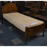 An Edwardian Walnut Single Bed with Mattress