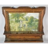 An Edwardian Oak Framed Wall Hanging Pipe Rack with Printed Panel Under Glass Depicting Maiden