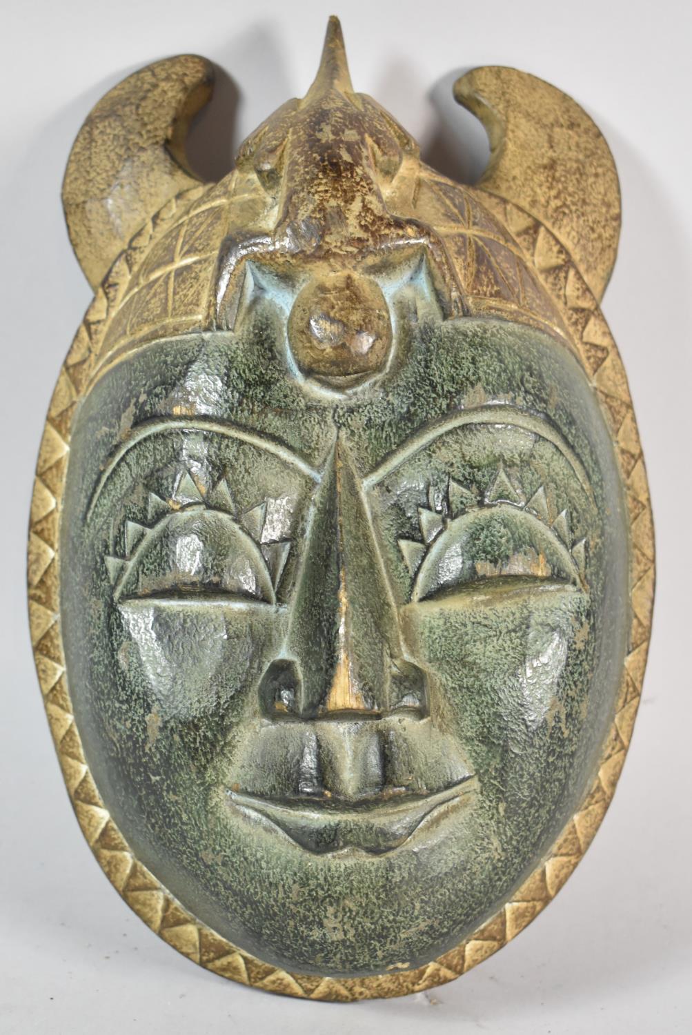 A Carved African Tribal Souvenir Mask, 31cm high