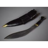 A Vintage Kukri Knife with Wooden Handle In Leather Sheath Complete with Two Small Knives, 41cm Wide