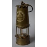 A Brass Miners Safety Lamp by the Protector Lamp and Lighting Company