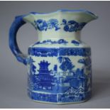 A Reproduction Blue and White Jug with Transfer Printed Oriental Scenes and with Dragon Stylised