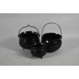 A Collection of Three Various Black Painted Iron Cauldrons, the Largest 31cm diameter