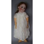 A Late 19th/Early 20th Century German Porcelain Head Doll with Open Mouth and Closing Eye,