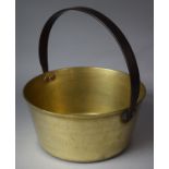 A Vintage Brass Jam Kettle with Iron Loop Handle, 30cm Diameter