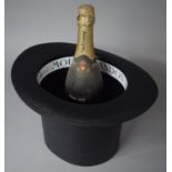 A Modern Moet and Chandon Ice Bucket in the form of a Top Hat, Together with a Bottle of Sparkling