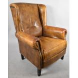 A Leather Upholstered Wing Armchair