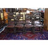 A Set of Eight Edwardian Carved and Inlaid Oak Framed Dining Chairs to Include Two Carvers