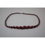 A Cherry Amber Necklace of Graduated Ovoid Beads, 57g Untested