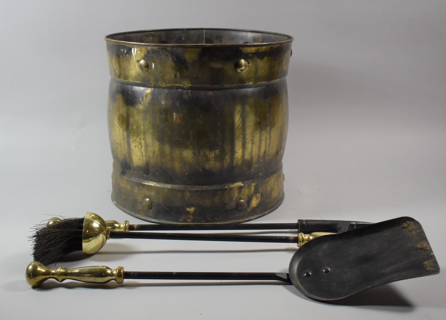 A Brass Coal Bucket and Set of Three Long Handled Fire Irons