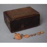 A Wooden Box with Sliding Lid Containing Carved Nut Shell Miniatures