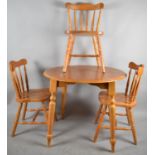 A Modern Circular Pine Effect Kitchen Table and Three Spindle Back Chairs, 90cm Diameter