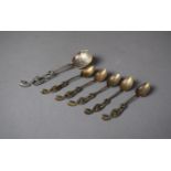 Five Eastern White Metal Coffee Spoons with Winged Serpent Finials Together with a Larger Example,
