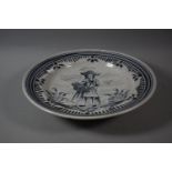 A Continental Delft Blue and White Crackle Glazed Charger Depicting Maiden with Basket of